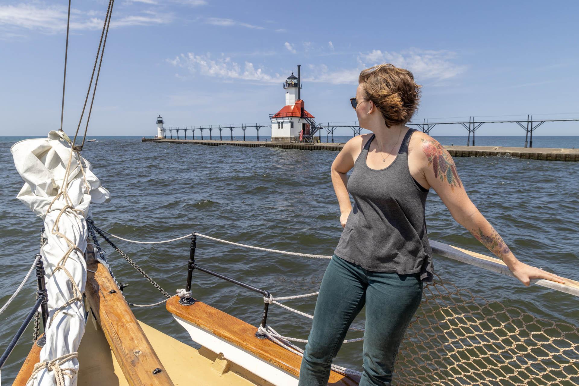 A woman on Tall Ship MJ by the lighthouse in St Joseph