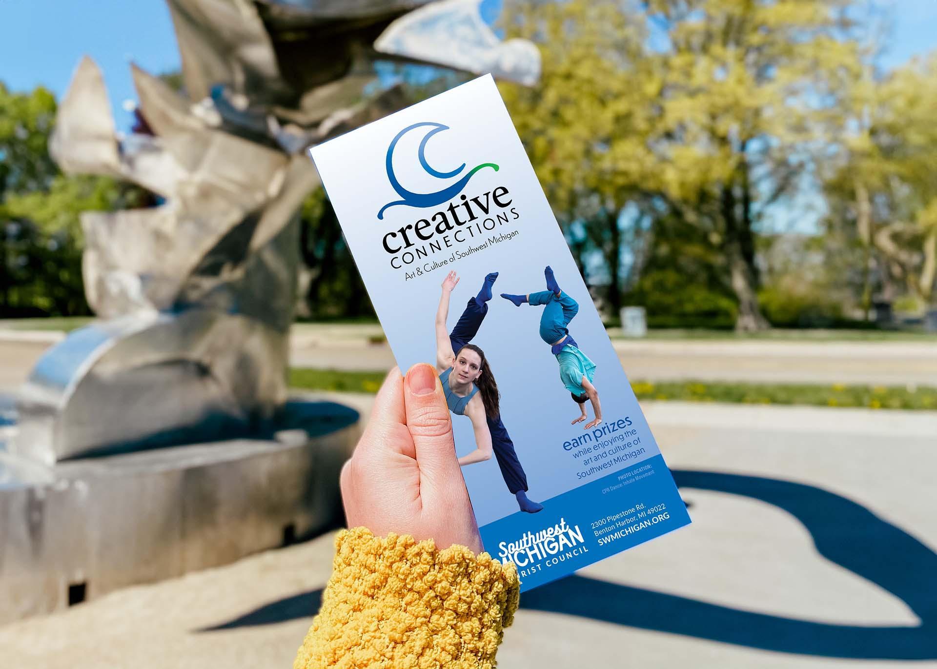 A person holding the Creative Connections brochure.